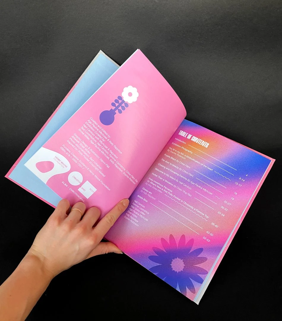 a book held open by a hand.