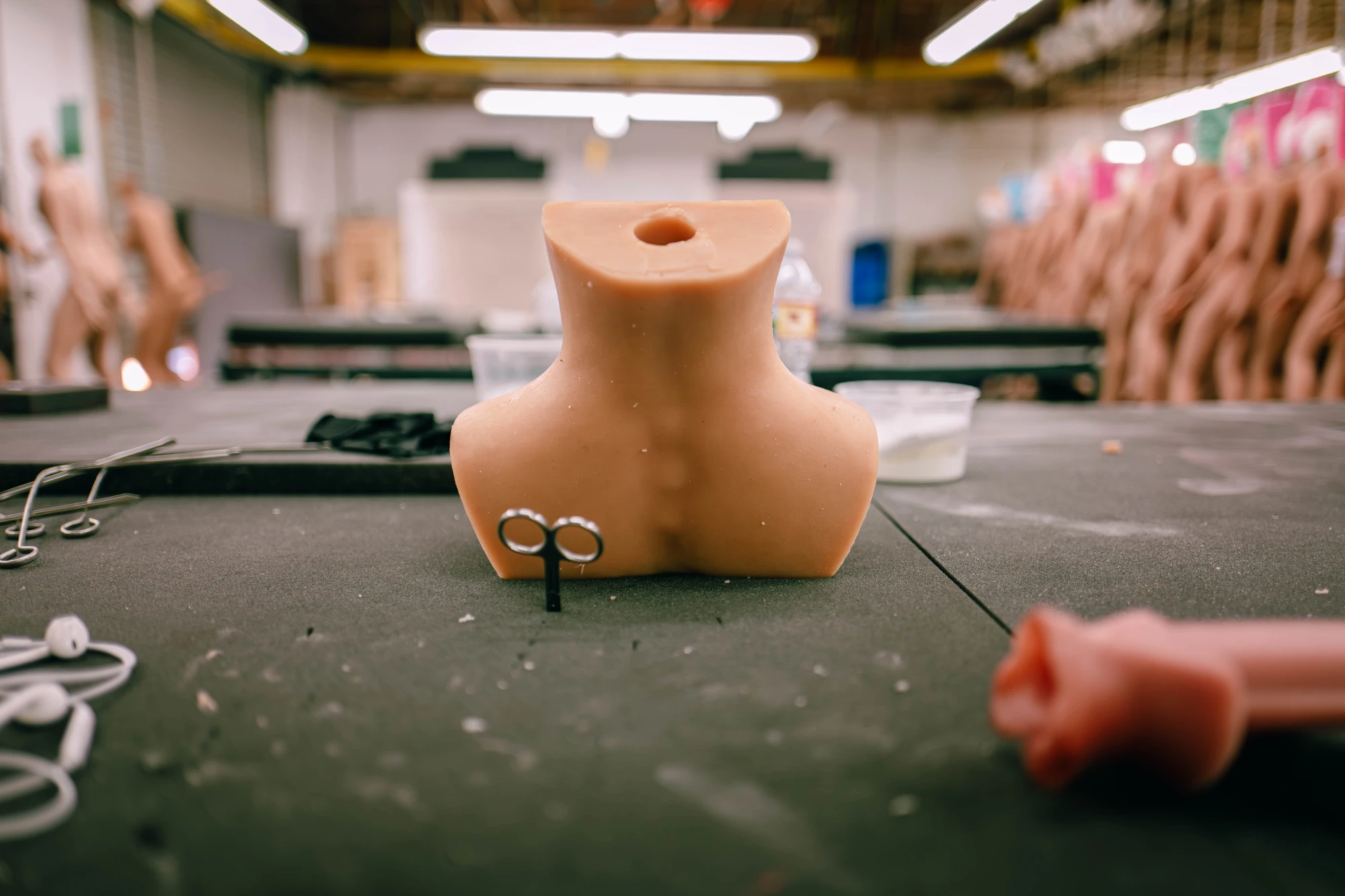 a sillicone spine sits on top of a table, with a pair of scissors.