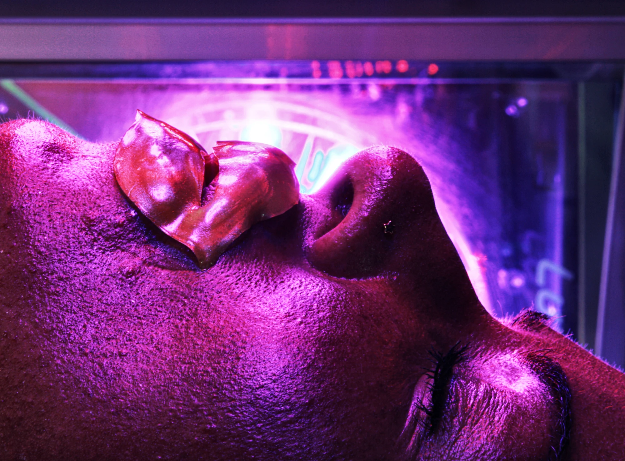 a close up of a woman's face, wearing a lip mask.