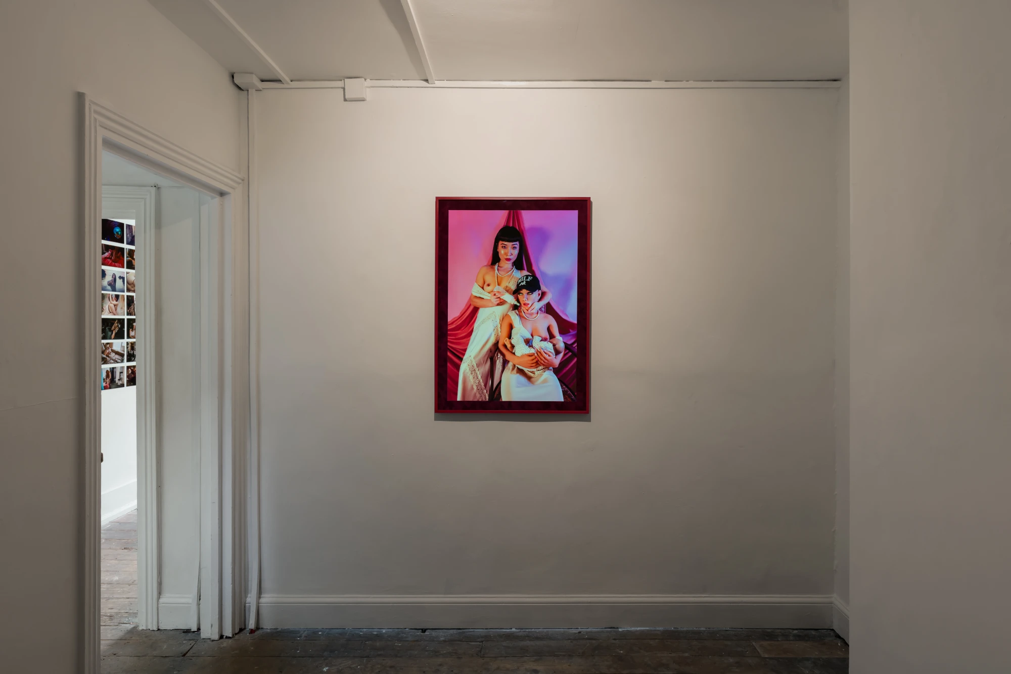 a photograph is displayed on a white wall.